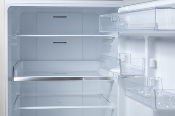 Opened empty refrigerator. Refrigerator open empty fridge inside interior. close up on empty refrigerator with door open
