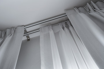 Two layers curtain with rails, installed on ceiling, translucent and blocking lights curtains - 372164739