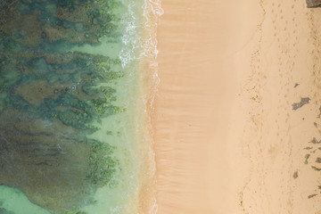 Fototapeta na wymiar Aerial view of sandy beach and ocean with waves