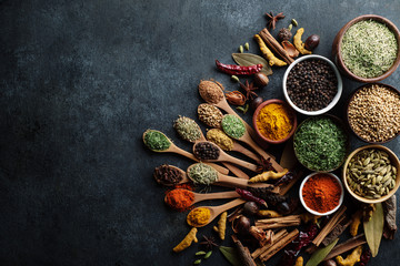 Spices and herbs arranged beautifully on a rustic background