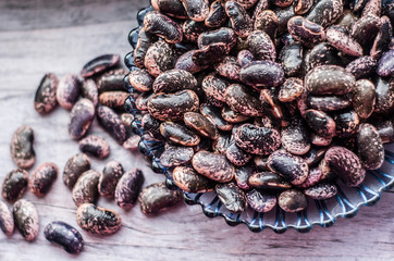 Purple beans on a plate. Food photo.