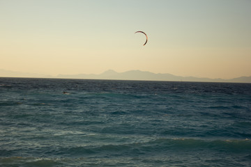Greece. Rhodes island. Rest at the sea. Euro-trip. Sea water surface. Mountains in the background.