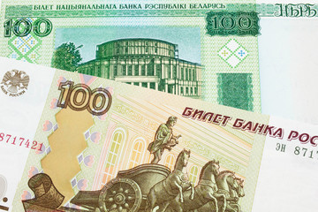 A macro image of a Russian one hundred ruble note paired up with a green one hundred ruble note from Belarus.  Shot close up in macro.