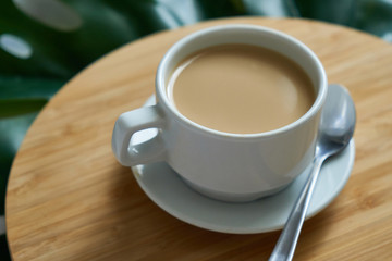 White cup of coffee latte on exotic background. Breakfast concept
