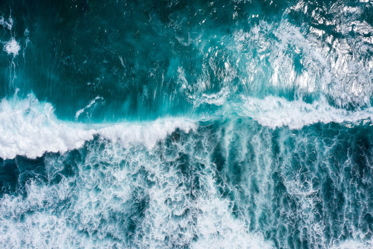 Aerial view to ocean waves. Blue water background