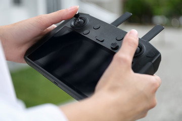 Woman with modern drone controller outdoors, closeup © New Africa