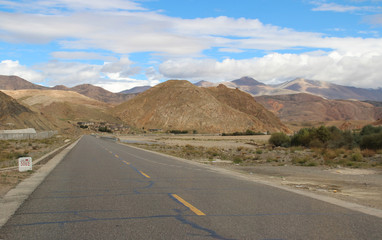 Road running through mountains in Tibet, China