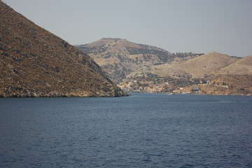 Greece. Rhodes island. Rest at the sea. Euro-trip. Sea water surface. Mountains in the background.