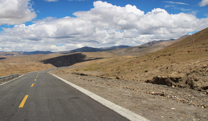 Road running through mountains in Tibet, China