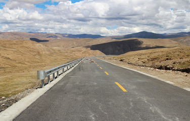 Road running through mountains in Tibet, China