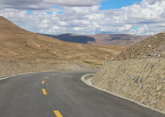 Road running through mountains in Tibet, China