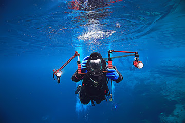 underwater photographer with a camera, diver hobby special underwater boxing with a camera
