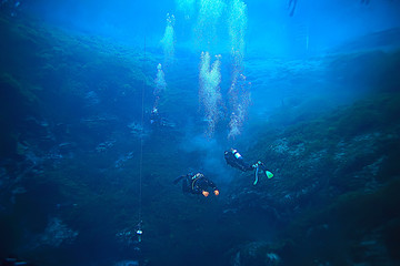 diver breathes air under water bubbles, releases gas, landscape underwater depth