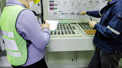 Engineers are in control room for high voltage electricity of factory, Safety patrol in...