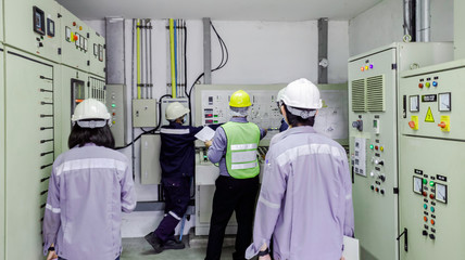 Engineers are in control room for high voltage electricity of factory, Safety patrol in...