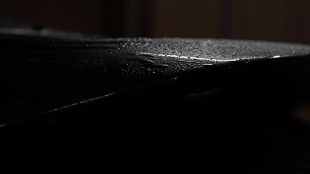 Roof from a black car in a car wash