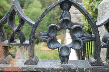 Close up of iron work fence, flower shape  with arch - 372176981
