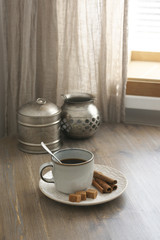 Coffee with cinnamon and silver utensils