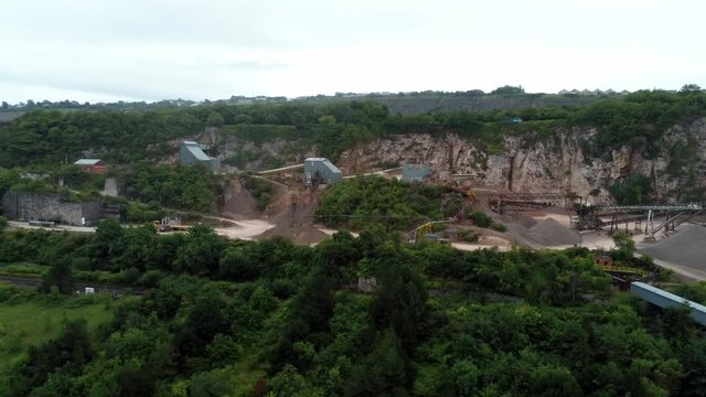 Cemex mining site on North Wales expressway traffic aerial descending view over construction site