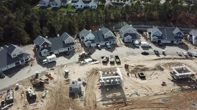 Drone pan up of a dirty construction site at a housing development