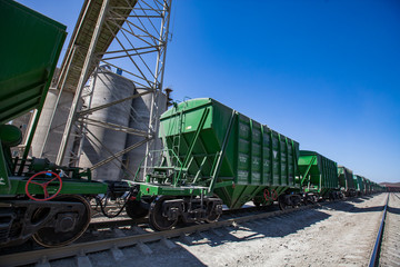 Mynaral/Kazakhstan: Modern cement plant in desert. Hopper cars with dry cement on railroad loading...