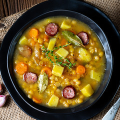 Rustic pea soup with bacon and sausages