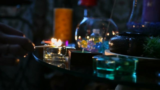 Esoteric Lights candles on the table. A mystical ritual in the clairvoyant's room.
