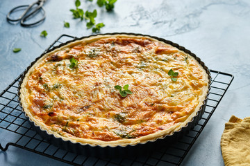 Quiche with ham and cheese. Open pie.