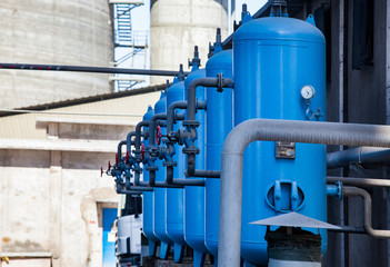 Jambyl Cement plant station of filtration and purification. Blue water storage tanks with valves...
