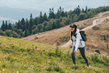 Fototapeta premium woman with backpack hiking in mountains