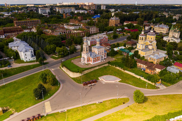 panoramic view of an old church in summer on a green hill against a cloudy sky background