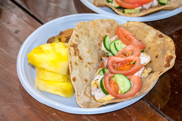 Fototapeta na wymiar healthy breakfast vegetables and meat on a tortilla