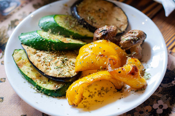 Grilled vegetables in a plate with spices, yellow sweet pepper, zucchini and eggplant
