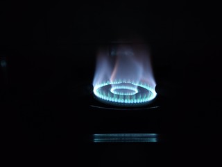 Blue and red flame on gas oven, closeup, kitchen