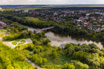 Fototapeta na wymiar a panoramic view from a drone of a dark river and green trees around in summer