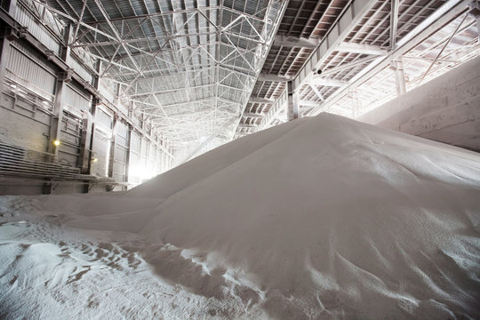 White heap or pile of salt granules (pellets) of phosphoric (phosphate) fertilizers on chemical plant.