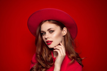 woman in red shirt with bright makeup and hat on her head emotions fashion style