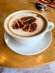 cup of coffee kept on wooden table 