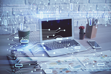 Double exposure of desktop computer and technology theme hologram. Concept of software development.