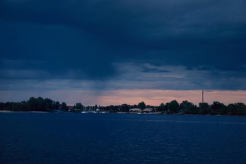 sunset over the river, beautiful sky, stormy clouds 