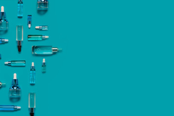 Natural Serums and face oils. Cosmetic hydrating serum in a glass bottle with pipette close up. Hyaluronic acid on abstract background top horizontal copyspace