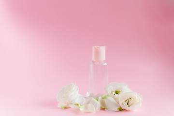 Obraz na płótnie Canvas Hand cream with flowers. Delicate skin care concept. Top horizontal view copyspace
