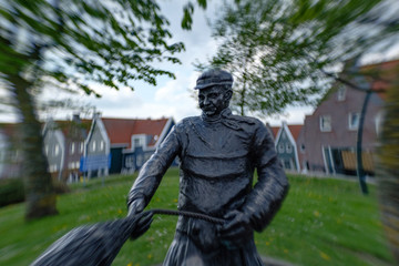 Fototapeta na wymiar statue of a fisherman with a net in Volendam