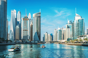 Fototapeta na wymiar Panorama of Dubai Marina in UAE, modern skyscrapers and port with luxury yachts.