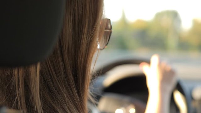 Young beautiful blonde woman driving car