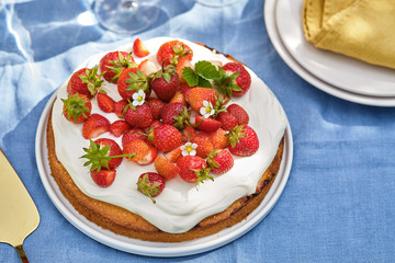 Pie with cream and strawberries on a summer background. . Homemade summer dessert.