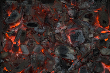 Burning coal background, close up of black and red burning coal