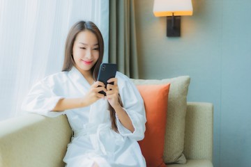 Portrait beautiful young asian woman use smart mobile phone on sofa