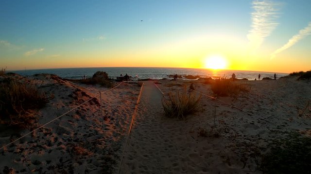 Asilomar State Beach in Monterey, California (USA). POV footage of a person walking towards the sunset. August 15, 2020.