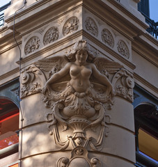 sculpture of a figurehead on the corner of a magnificent building
